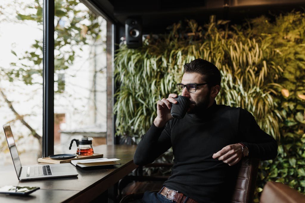 Man enjoying a cup of coffee and practicing mindset development.