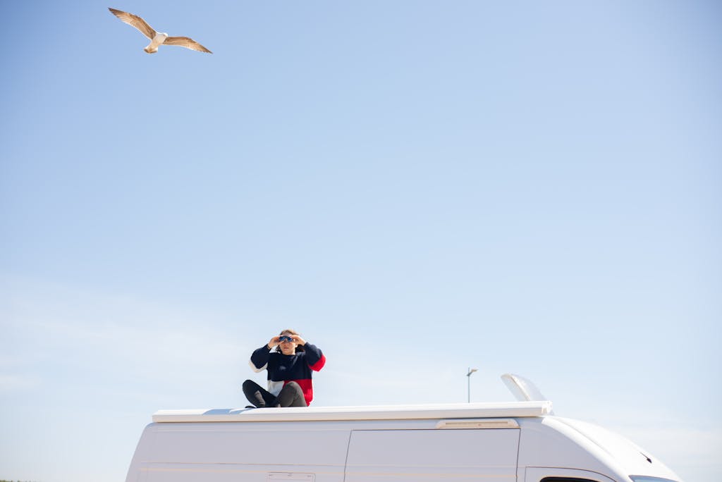Woman birdwatching using binoculars reframing her mindset. This is her superpower.